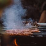 Grilling meat on a charcoal BBQ